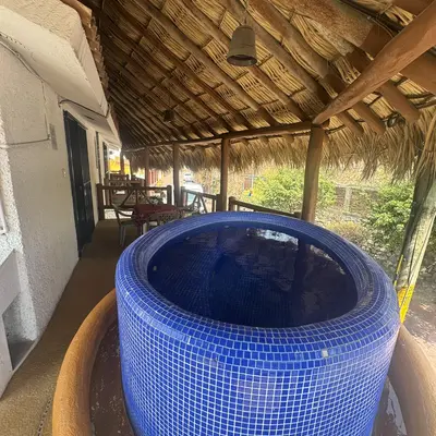 Palapa-covered walkway with jacuzzi