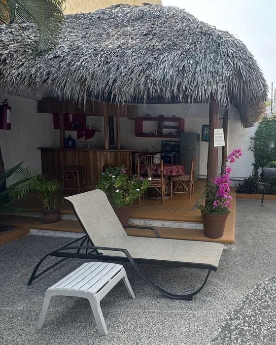 Palapa with a lounger and garden at Villas Mercedes