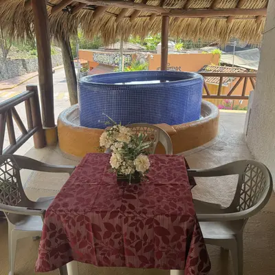 Terrace with a table in front of the private jacuzzi