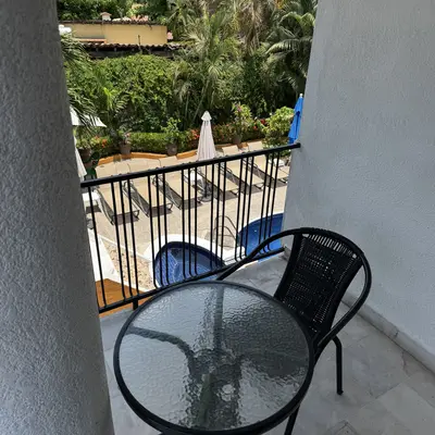 Terrace with a table overlooking the garden and the pool
